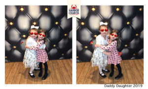 A photo of two little girls smiling for the Daddy Daughter 2019 event.