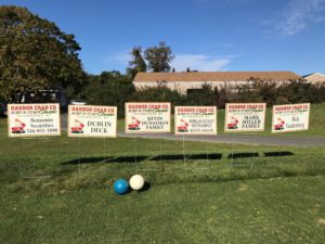 A photo of signs featuring sponsors of the golf outing.