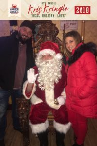A couple posing for a photo with Santa.
