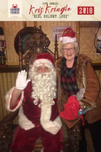 A woman posing for a photo with Santa.