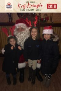 Three girls posing for a photo with Santa.