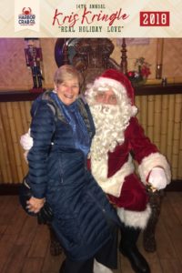 A photo of a woman posing for a picture with Santa.