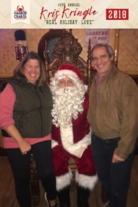 A couple posing for a photo with Santa.