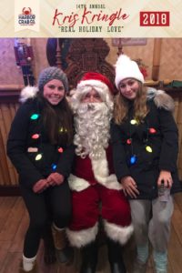 Two girls posing for a photo with Santa.
