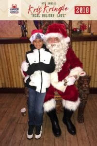 A child posing for a photo with Santa.