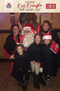 A family posing for a photo with Santa.