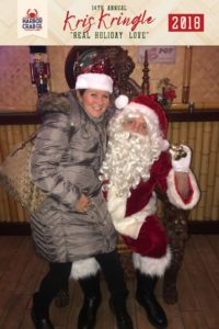 A woman posing for a photo with Santa.